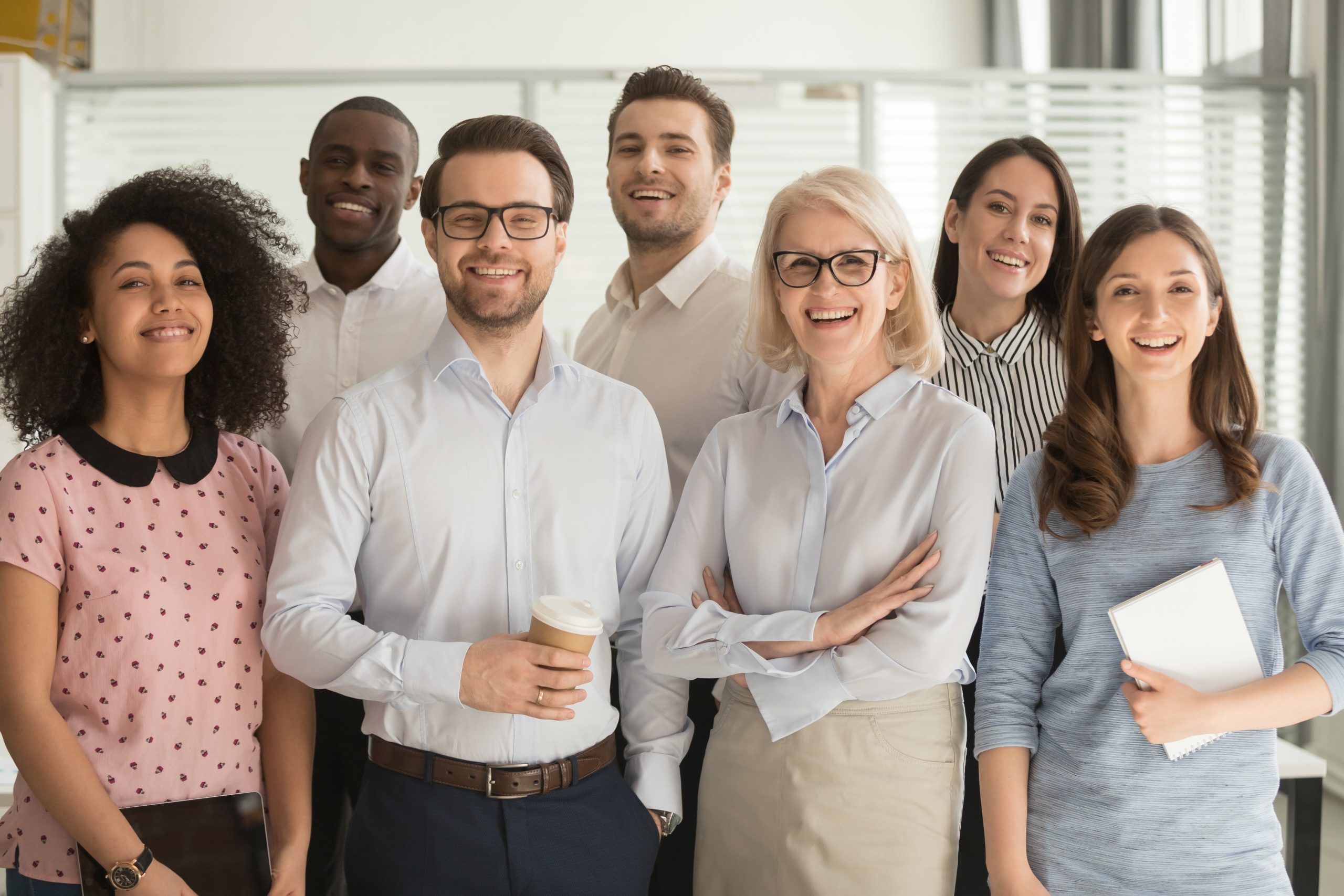 Smiling diverse employees posing for photo in office