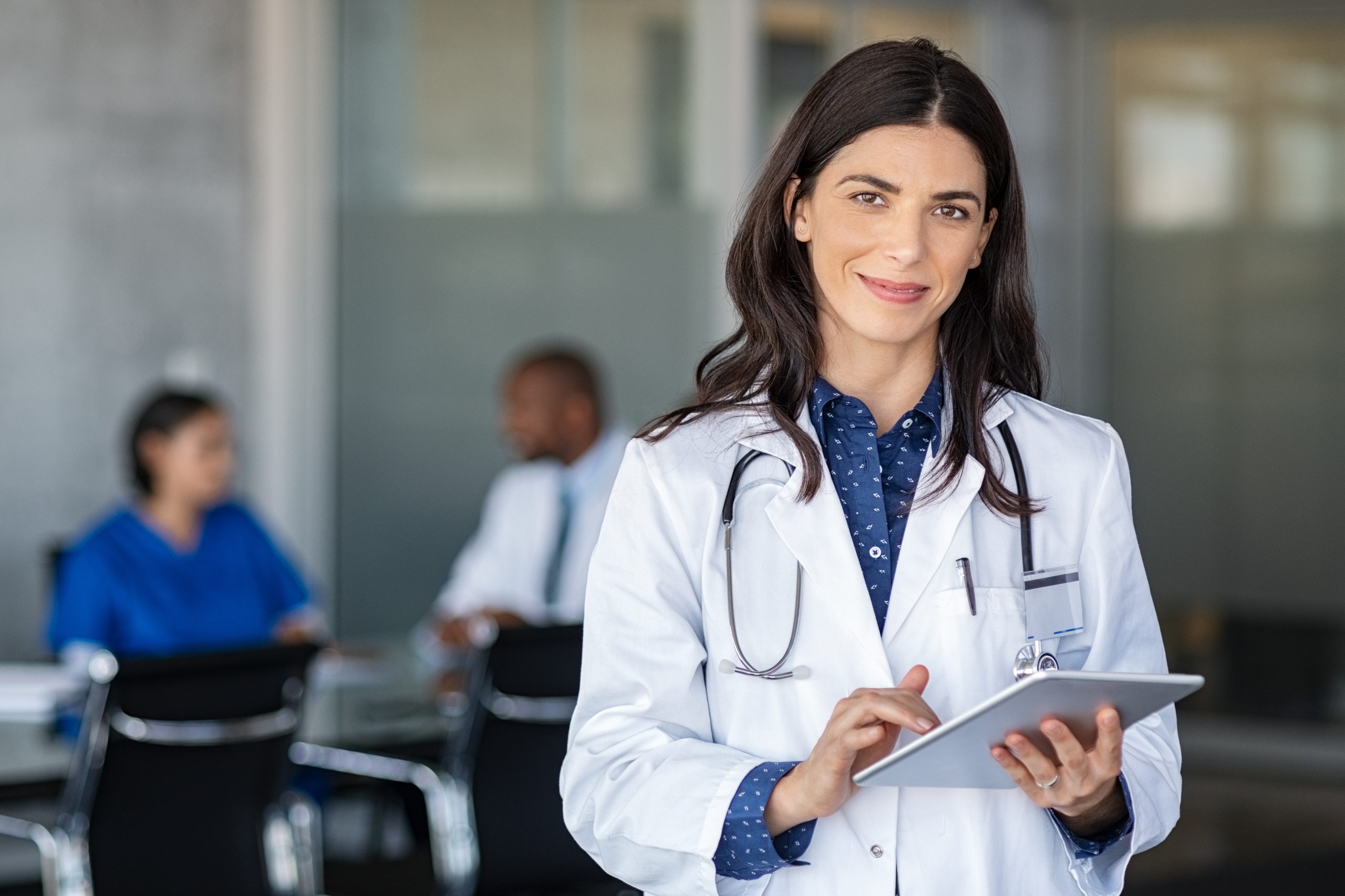 Doctor holding digital tablet at meeting room