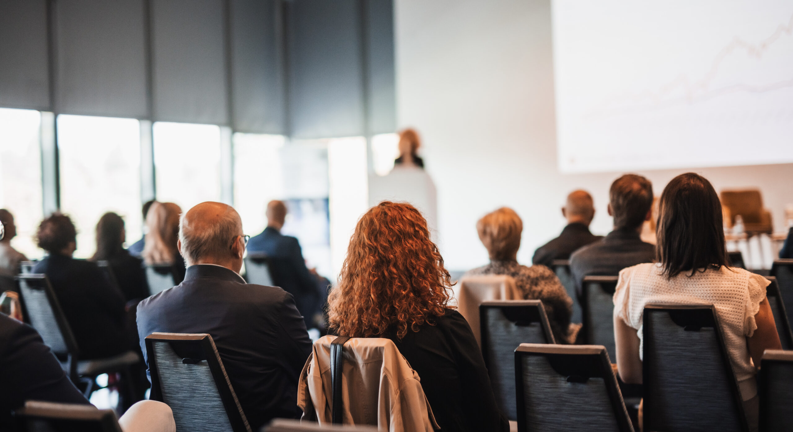 Woman giving presentation on business conference event.